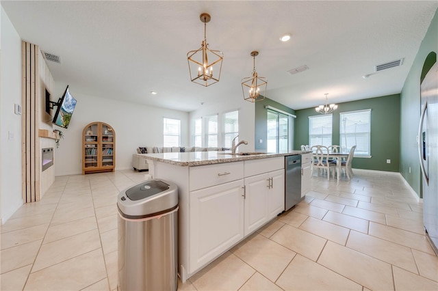 kitchen featuring dishwasher, sink, white cabinetry, a center island with sink, and decorative light fixtures