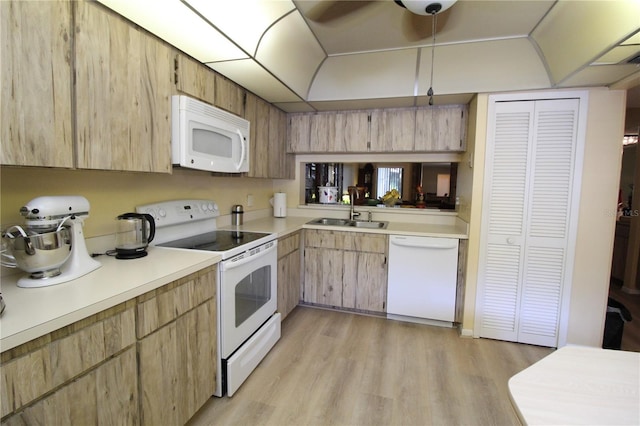 kitchen featuring light brown cabinetry, light hardwood / wood-style flooring, sink, and white appliances