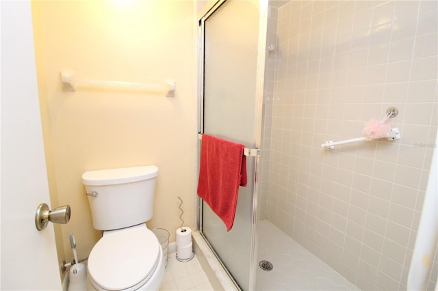 bathroom with tile patterned flooring, an enclosed shower, and toilet