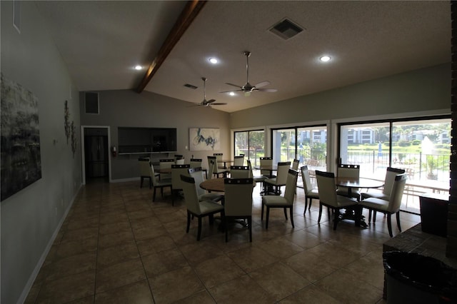 tiled dining space with ceiling fan, beamed ceiling, and high vaulted ceiling