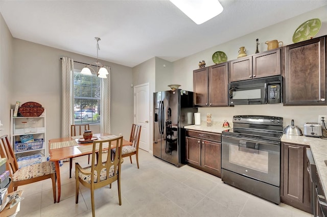 kitchen featuring hanging light fixtures, light tile patterned flooring, black appliances, dark brown cabinets, and a chandelier