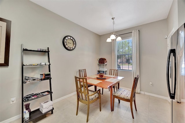 tiled dining area featuring an inviting chandelier