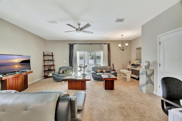 living room with ceiling fan with notable chandelier and light carpet