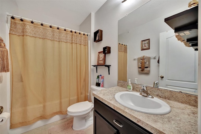 bathroom with vanity, tile patterned flooring, and toilet