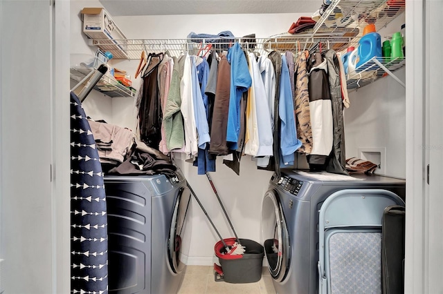 spacious closet with tile patterned flooring and washing machine and dryer