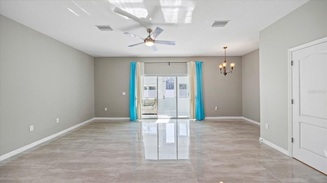 empty room featuring ceiling fan with notable chandelier