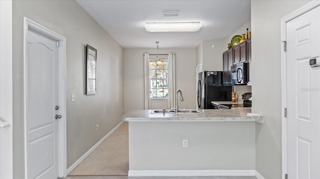 kitchen featuring sink, black fridge, range with electric stovetop, kitchen peninsula, and dark brown cabinetry