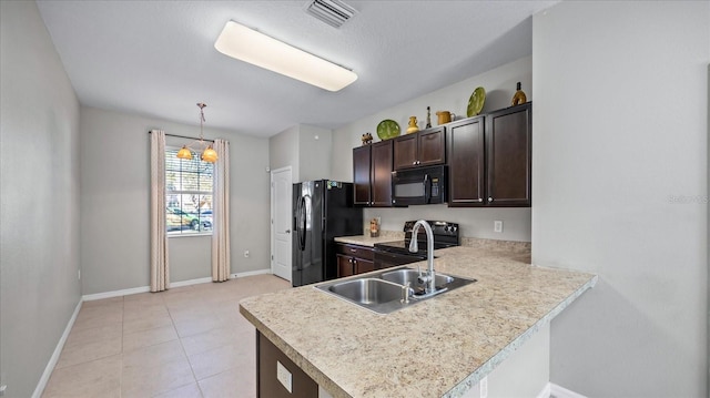 kitchen featuring dark brown cabinetry, black appliances, pendant lighting, sink, and kitchen peninsula