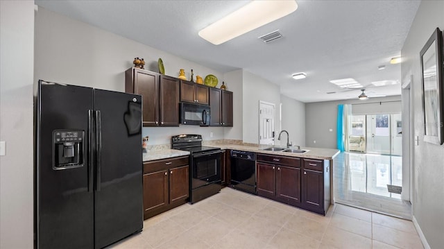 kitchen with light tile patterned floors, sink, black appliances, kitchen peninsula, and dark brown cabinets