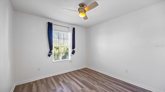 spare room with hardwood / wood-style flooring and ceiling fan