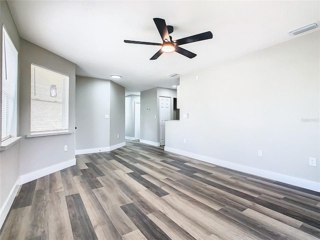 spare room with ceiling fan and dark wood-type flooring