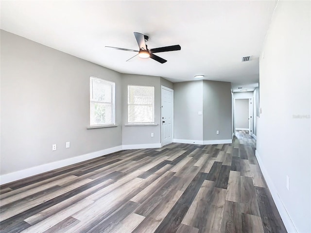 unfurnished living room featuring ceiling fan and dark hardwood / wood-style floors