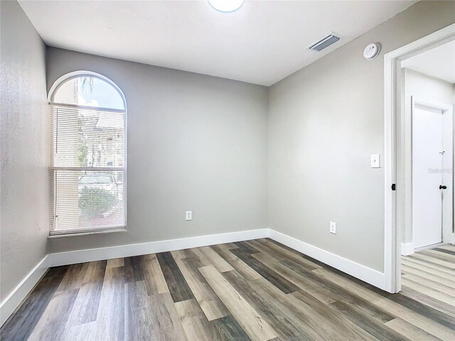 unfurnished room featuring hardwood / wood-style flooring