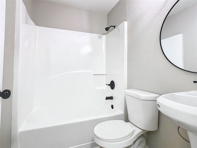 bathroom with bathtub / shower combination and toilet