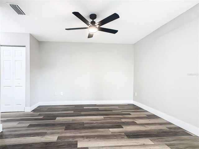 unfurnished room featuring ceiling fan and dark hardwood / wood-style floors