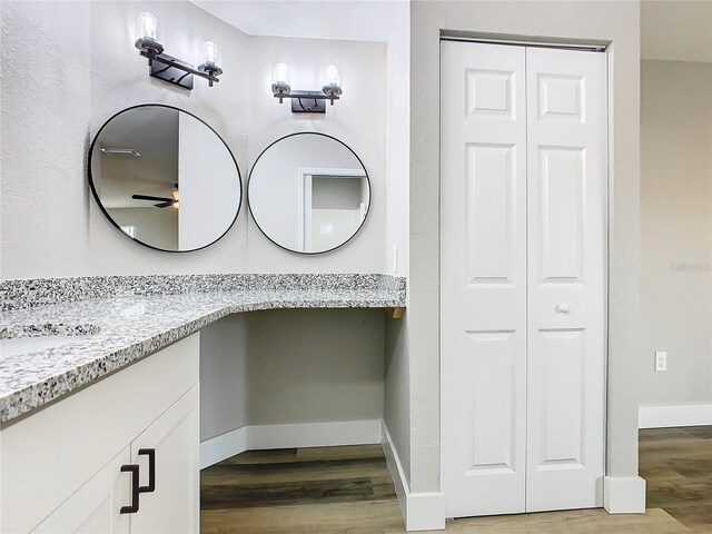 bathroom with ceiling fan, vanity, and hardwood / wood-style floors