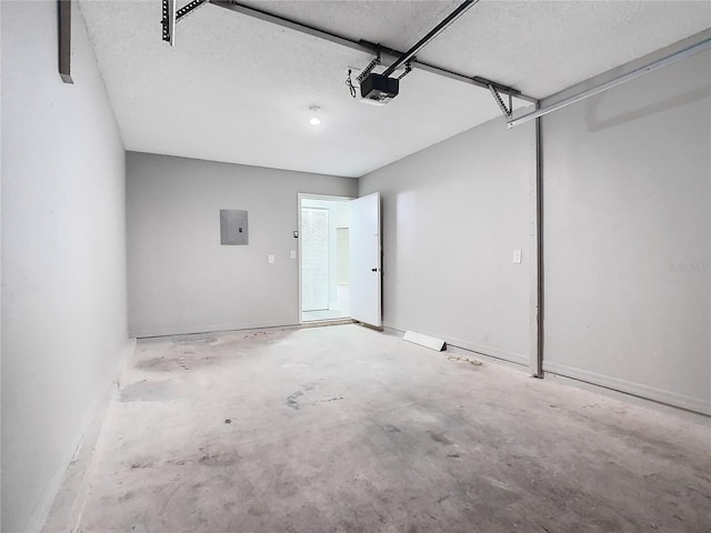 garage featuring electric panel and a garage door opener