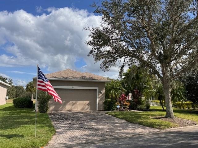 view of front of property with a garage and a front lawn