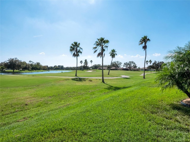 surrounding community featuring a yard and a water view