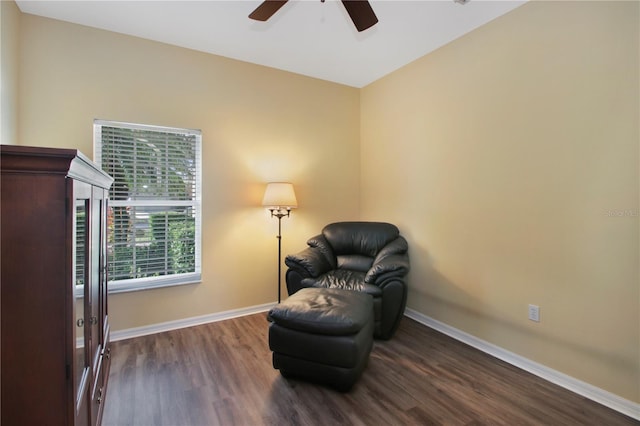 sitting room with dark hardwood / wood-style floors and ceiling fan