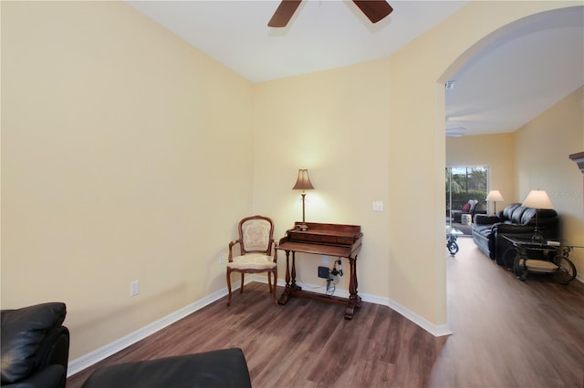 living area with hardwood / wood-style flooring and ceiling fan