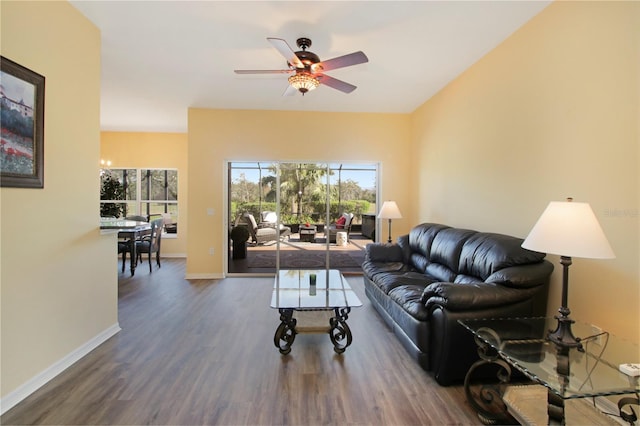 living room with ceiling fan and dark hardwood / wood-style floors