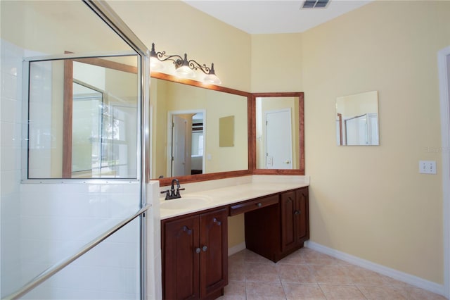 bathroom featuring vanity, tile patterned floors, and walk in shower