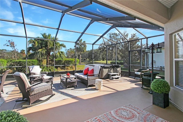 view of patio / terrace with a lanai, a hot tub, and an outdoor hangout area