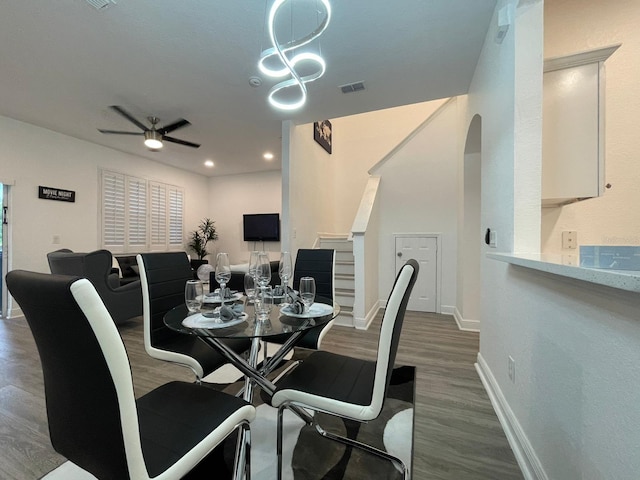 dining area with ceiling fan and dark hardwood / wood-style floors