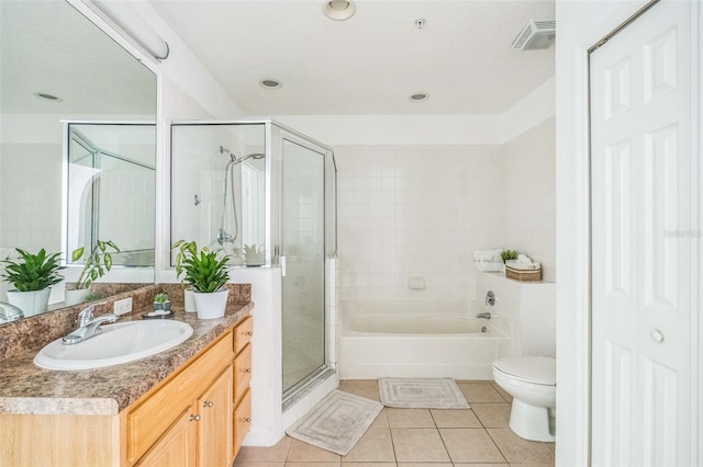 full bathroom with tile patterned floors, independent shower and bath, vanity, and toilet