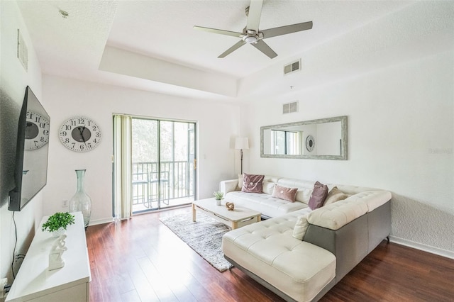 living room with dark hardwood / wood-style floors and ceiling fan