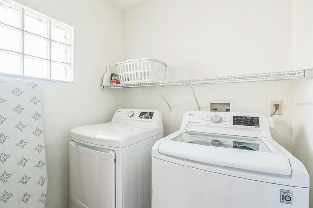 clothes washing area featuring separate washer and dryer