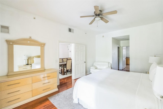 bedroom with ceiling fan and dark hardwood / wood-style flooring