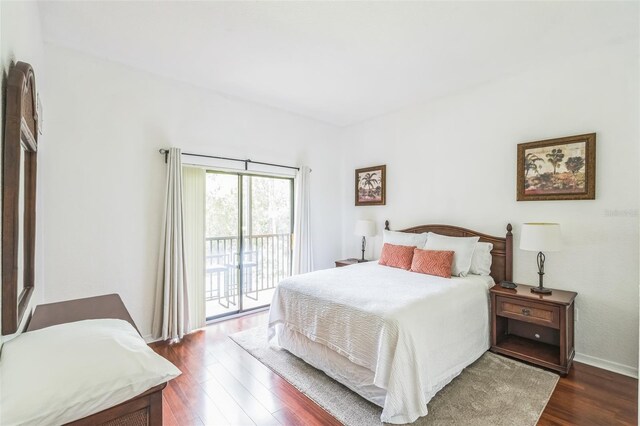 bedroom featuring access to outside and dark hardwood / wood-style flooring