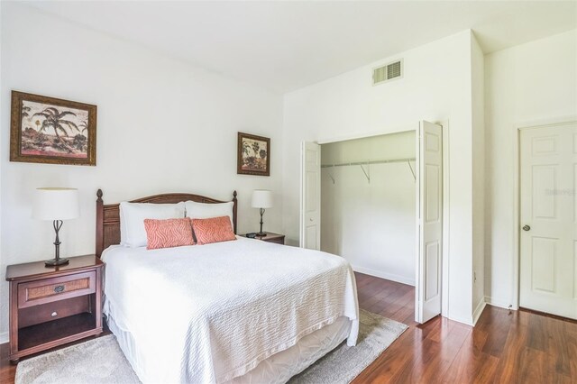 bedroom featuring dark hardwood / wood-style flooring and a closet