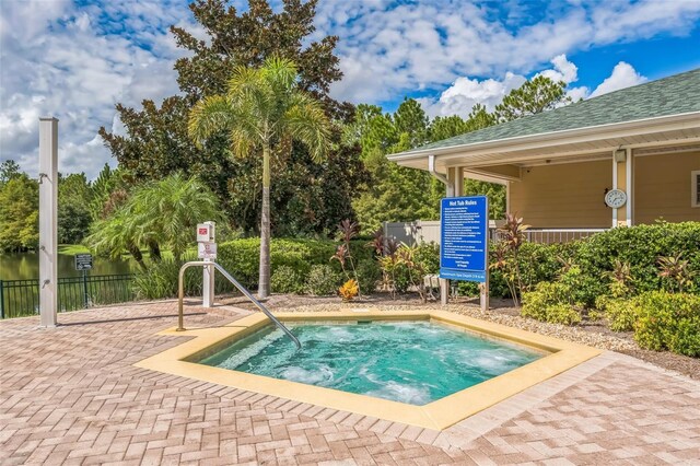 view of pool with a hot tub