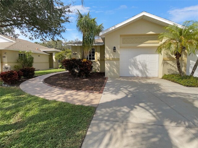 416 28th St W, Palmetto, FL 34221 - single story home featuring concrete driveway, an attached garage, and stucco siding