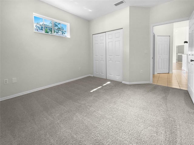 unfurnished bedroom with carpet and a closet