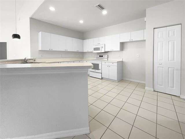 kitchen with range with electric stovetop, kitchen peninsula, and white cabinetry