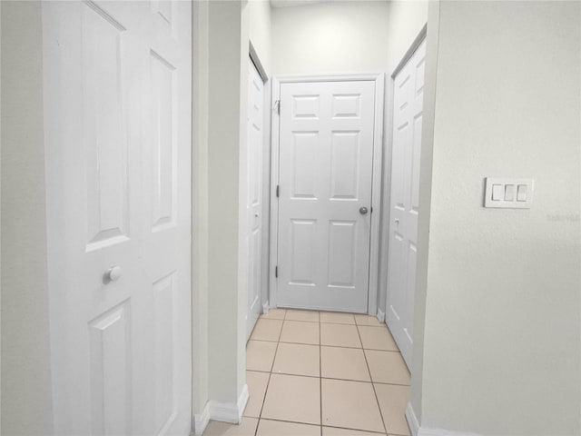 corridor with light tile patterned flooring