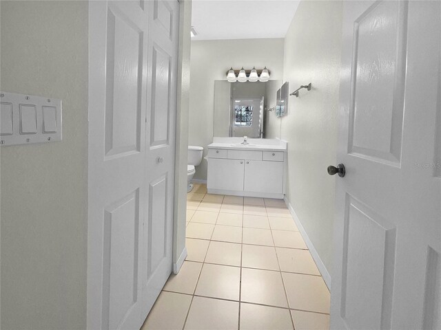 bathroom with vanity, toilet, and tile patterned floors