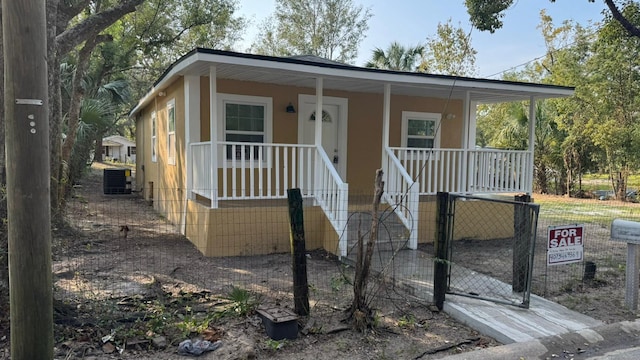 view of front facade with a porch and central AC unit