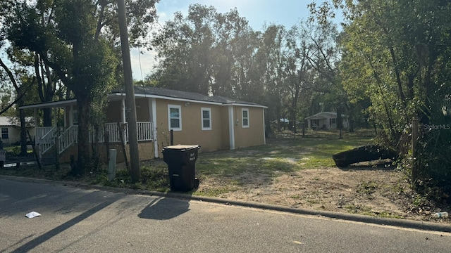 1517 S Campbell St, Perry, FL 32348 - view of front of home featuring stucco siding and a porch