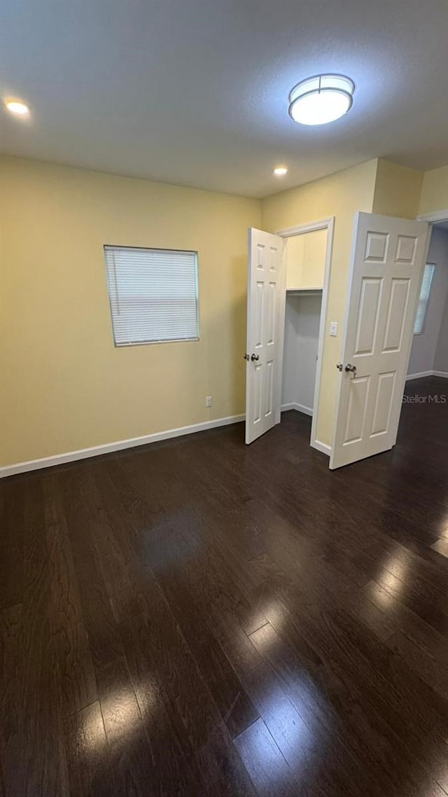 spare room with dark wood-type flooring