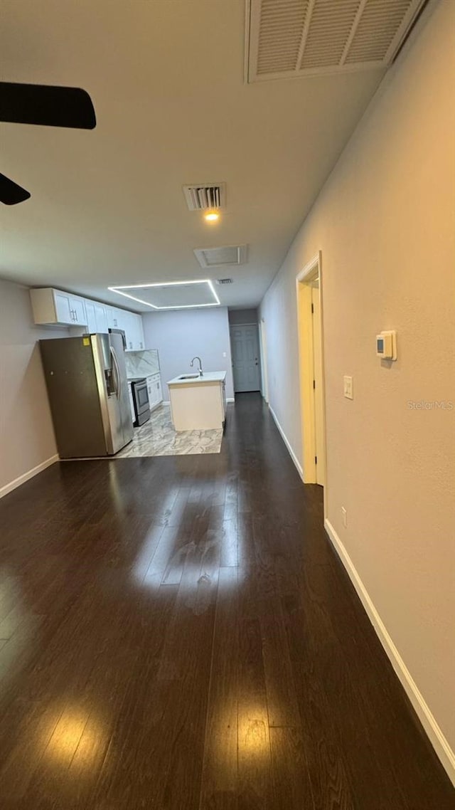 1517 S Campbell St, Perry, FL 32348 - unfurnished living room featuring dark wood-style flooring and ceiling fan
