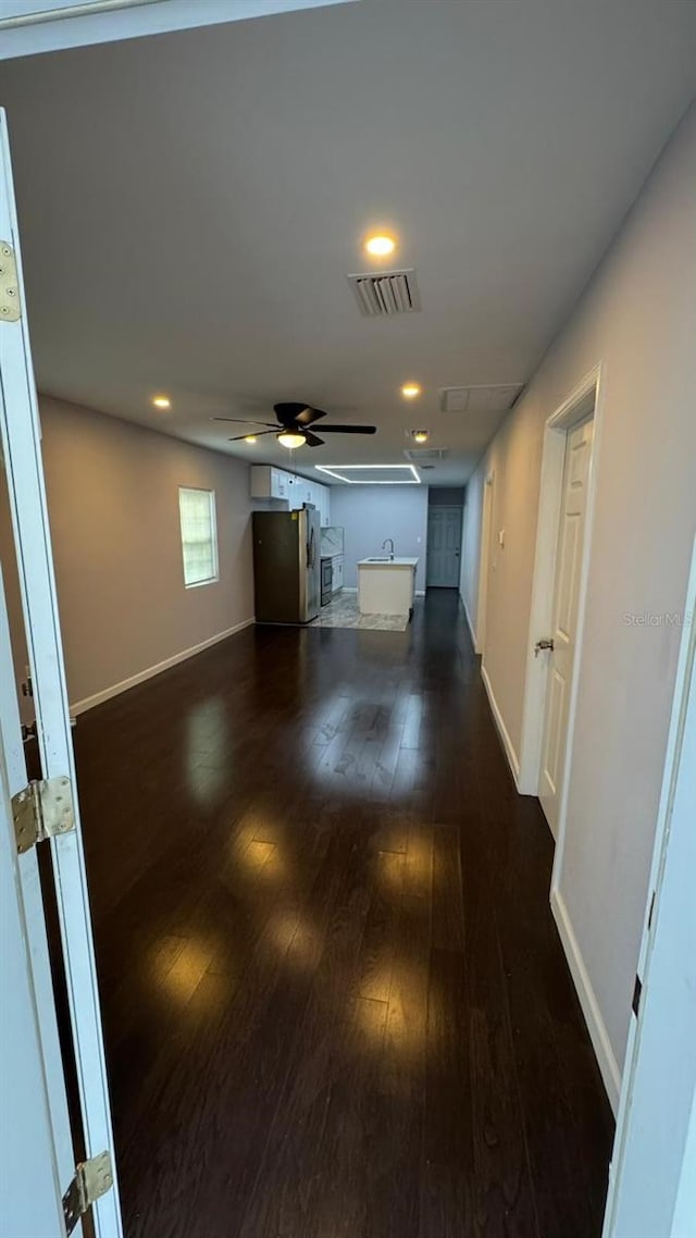 interior space featuring ceiling fan and dark hardwood / wood-style flooring