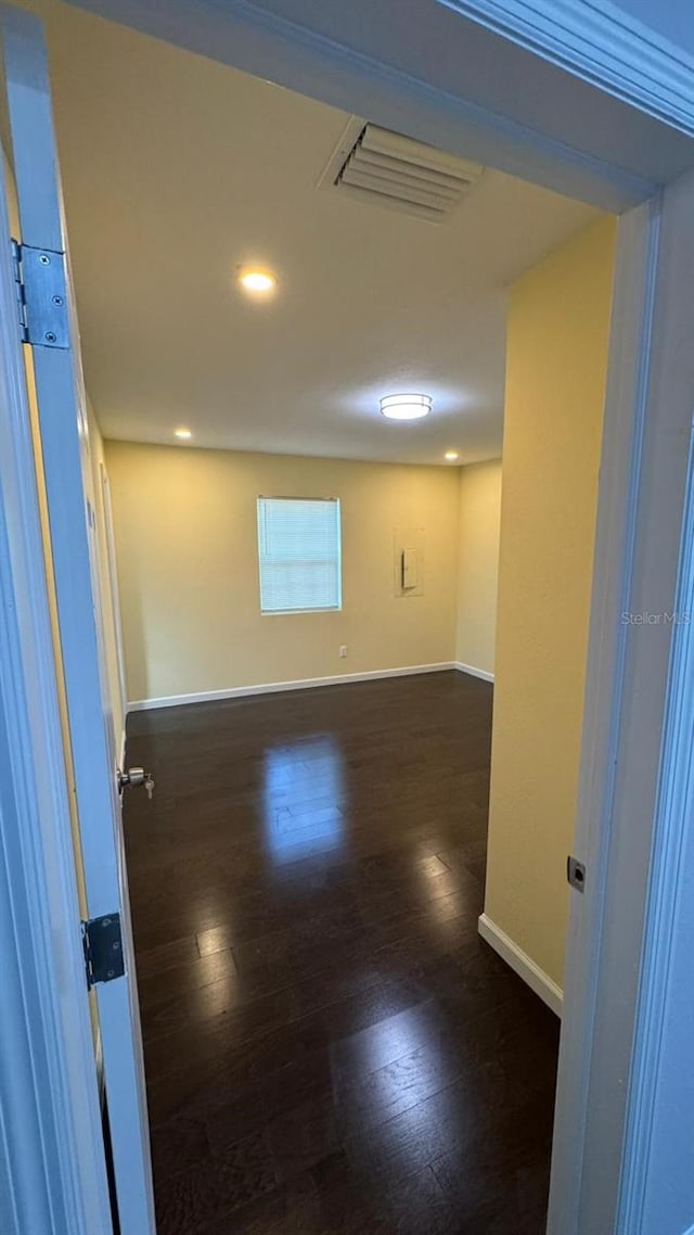 unfurnished room with dark hardwood / wood-style floors