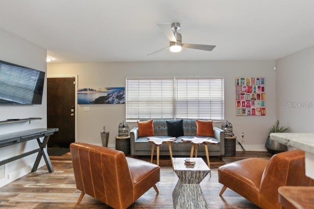 living room featuring light hardwood / wood-style floors and ceiling fan