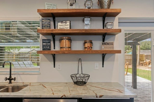 room details featuring sink and light stone counters