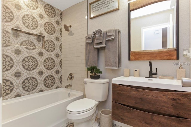 full bathroom featuring vanity, tiled shower / bath combo, and toilet